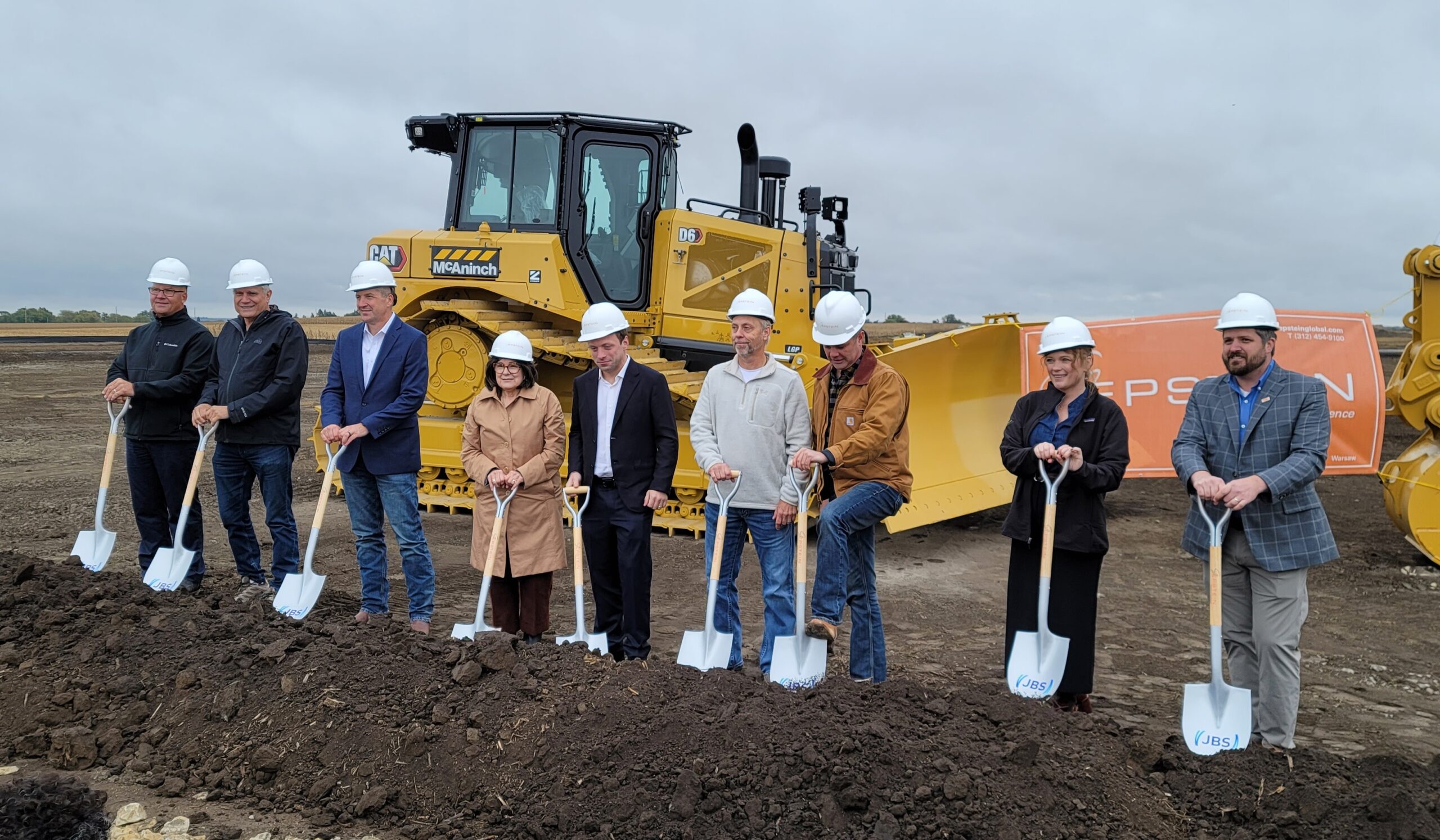 Wesley Batista Filho, fifth from left, joins officials holding shovels at the Perry, Iowa, sausage-plant groundbreaking