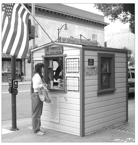 Historical black-and-white photograph of Paul’s Newsstand at Santa Clara Avenue and Park Street in Alameda