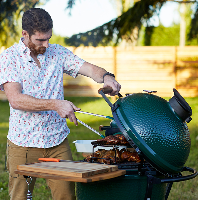 A cook using a Big Green Egg grill during a WH inc. campaign