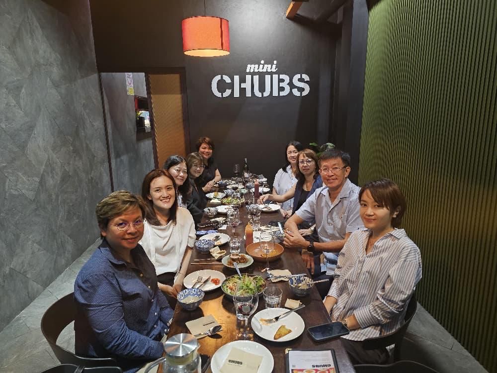 Soo Wai Har and a group of colleagues and business contacts gathered around a restaurant table