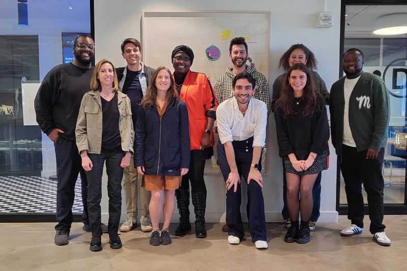 Members of Muck Rack's editorial team gathered in an office