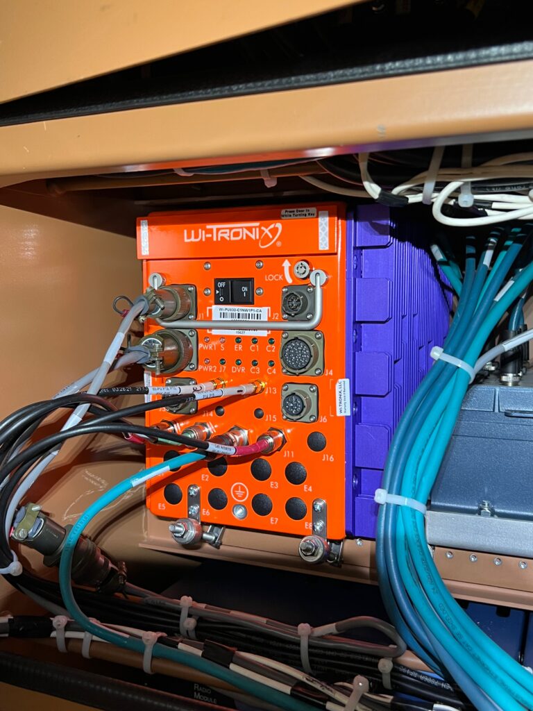 Wi-Tronix onboard unit fitted among bundles of labeled wires