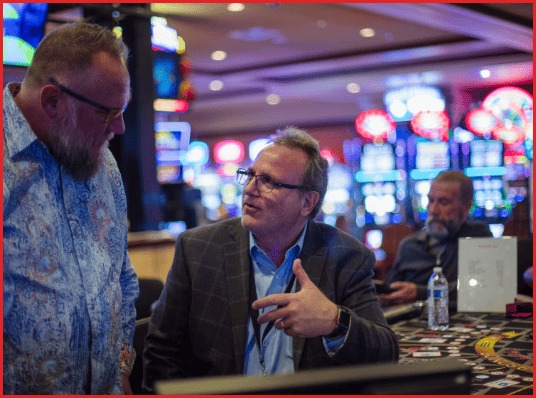 WickedThink CEO Kim Shugart speaking with a client on a casino floor