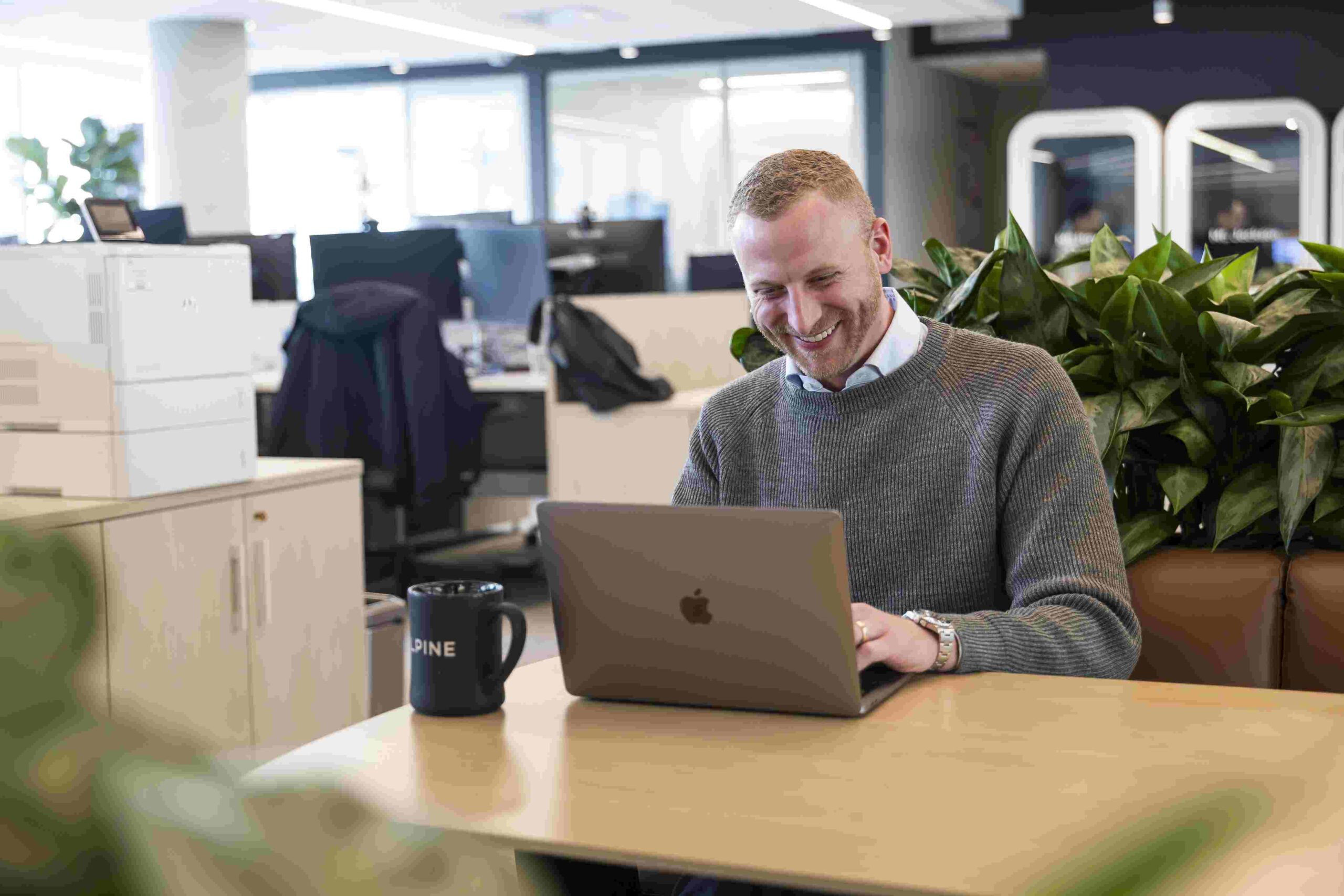 Will Chance working at a laptop in Alpine’s office