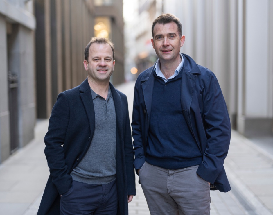 AmplifyME co-founders Piers Curran and Will de Lucy standing together outdoors