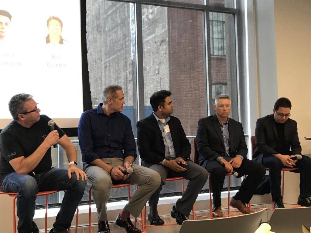Bill Baxter, far left holding a microphone, sits with four other speakers at an AWS IoT panel in San Francisco.
