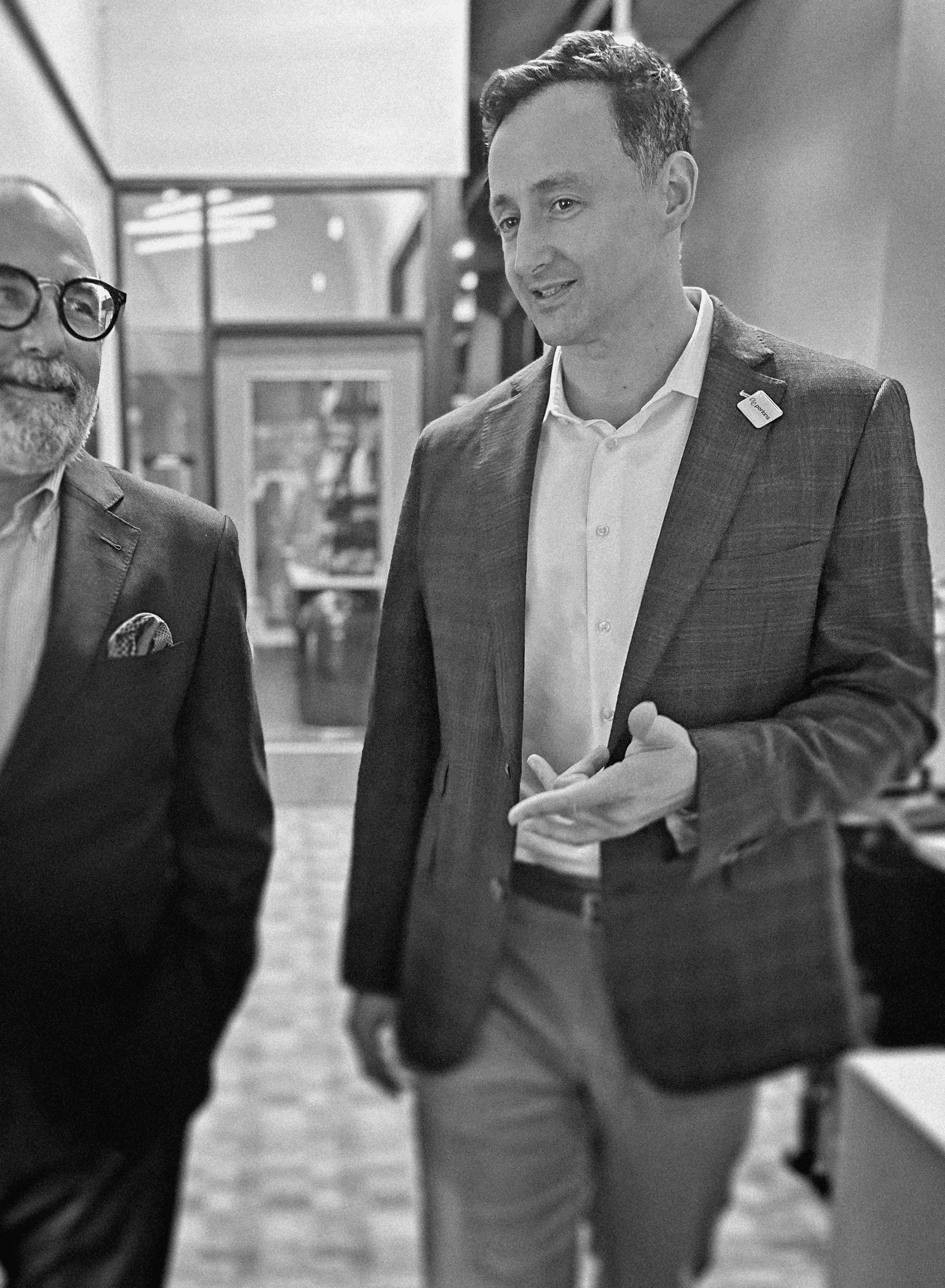 William C. Short, right, gesturing during a conversation in a black-and-white candid photograph