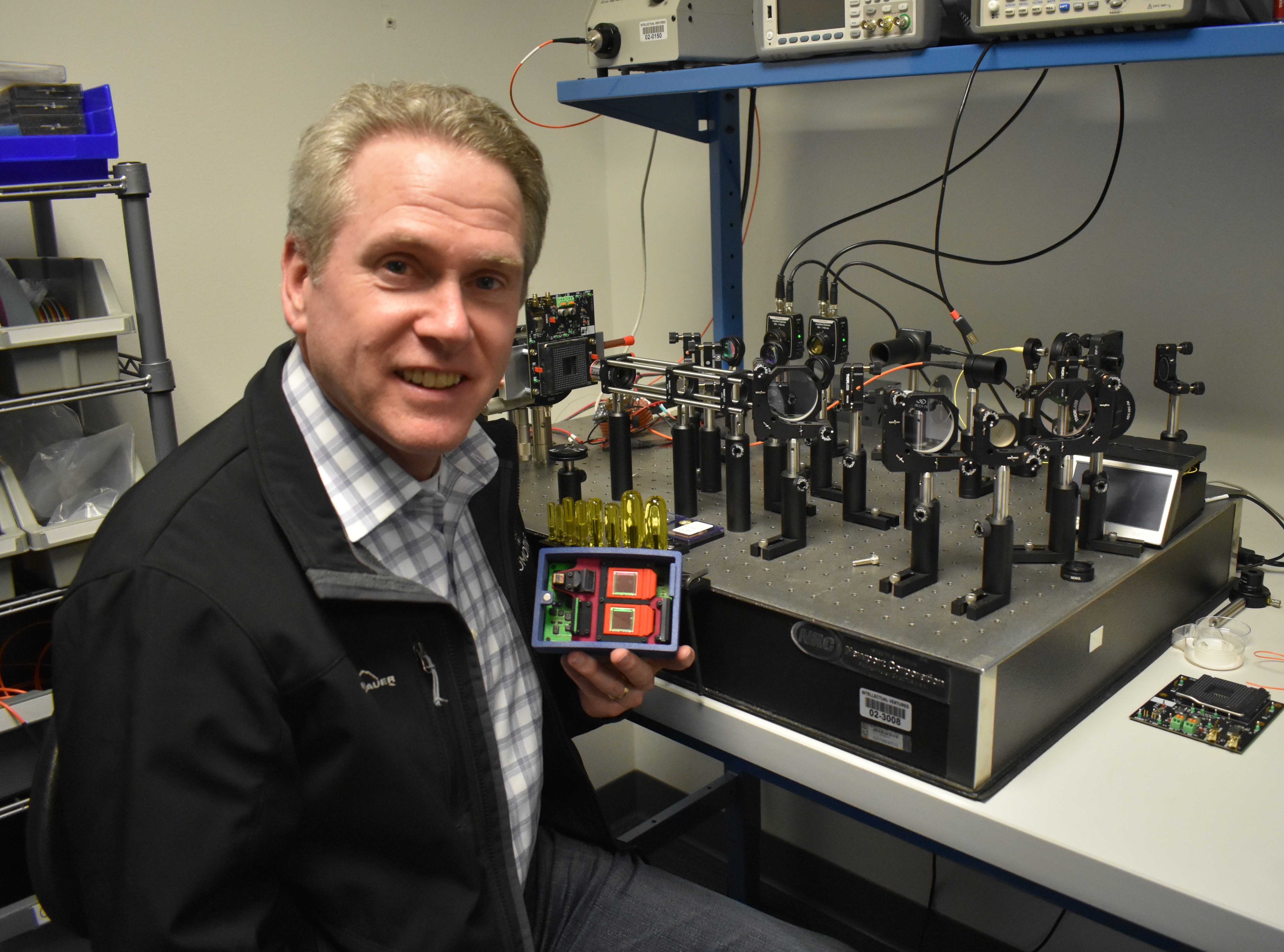 William Colleran demonstrating the interior of an early Lumotive lidar prototype