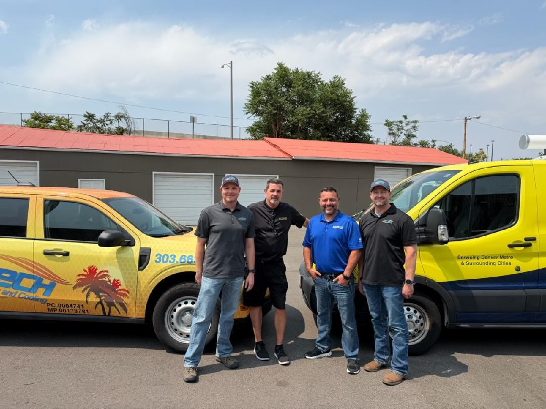 Four home-services team members standing between yellow service vehicles in the photograph accompanying the Nytech and Ultimate partnership announcement.