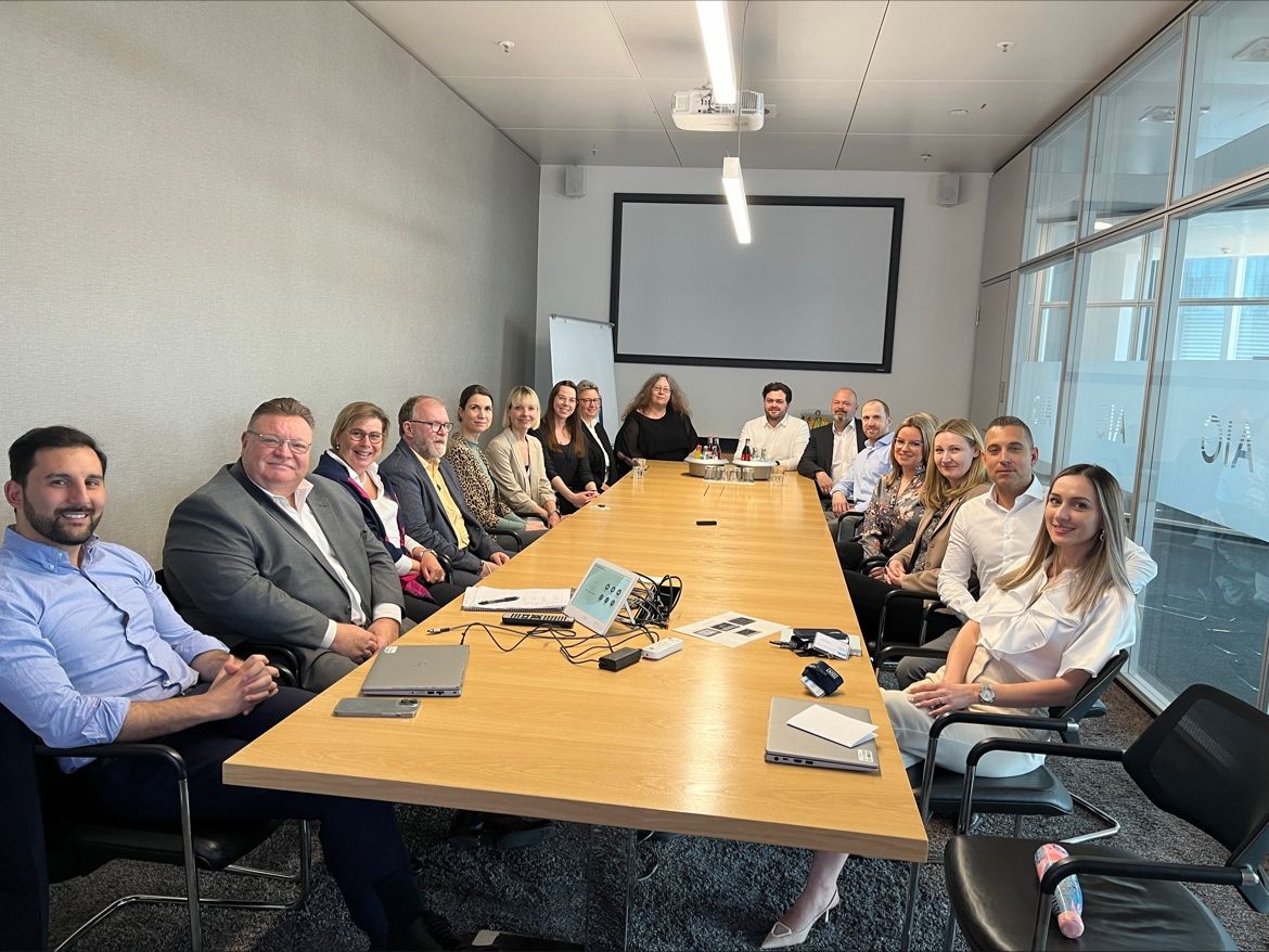 AIG colleagues gathered around a long meeting table during the Frankfurt visit