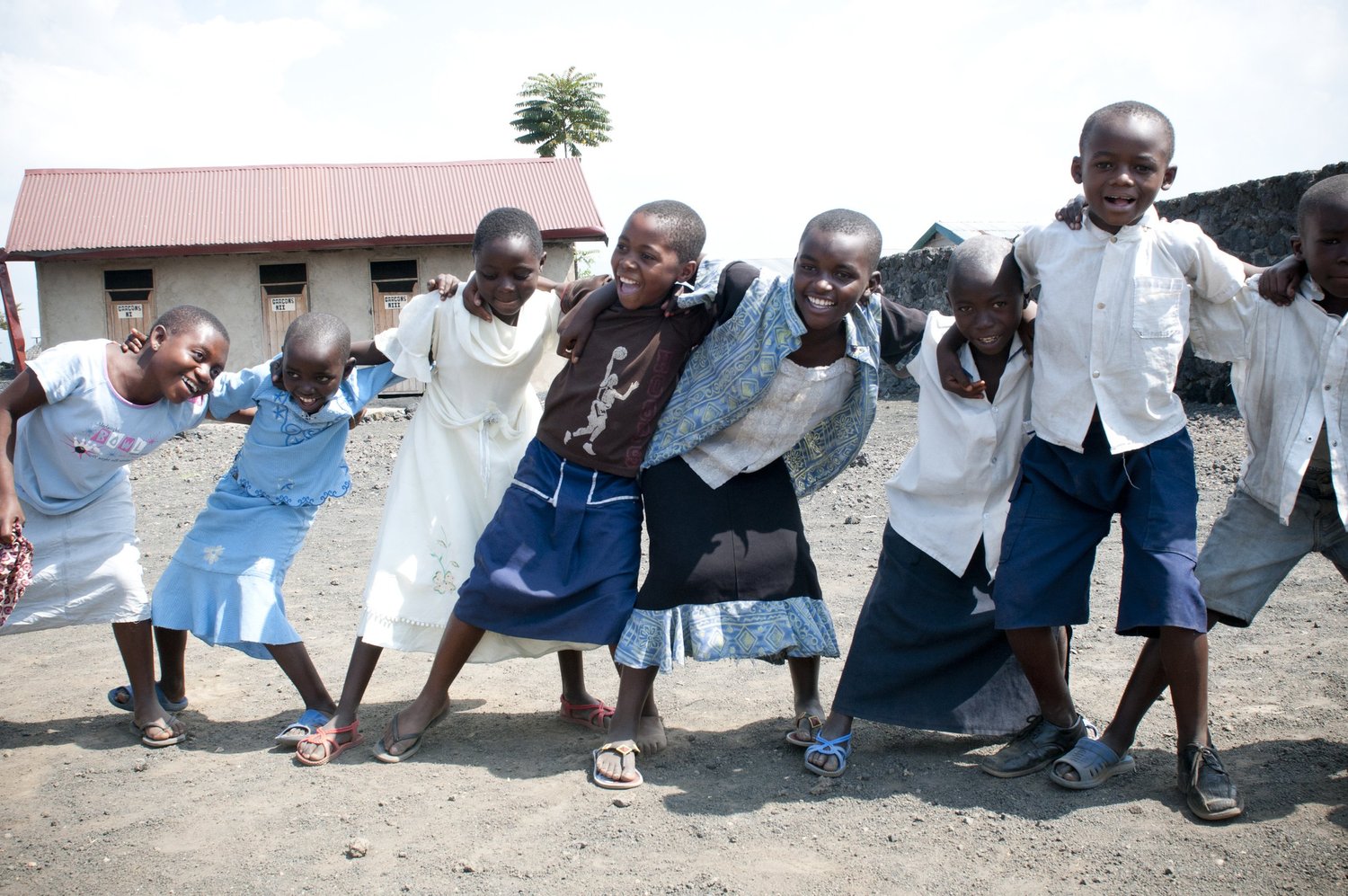 A group of children standing arm in arm in eastern Congo