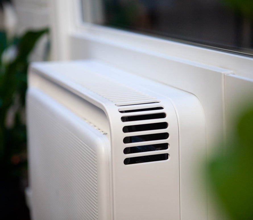A white Windmill air conditioner installed in a window
