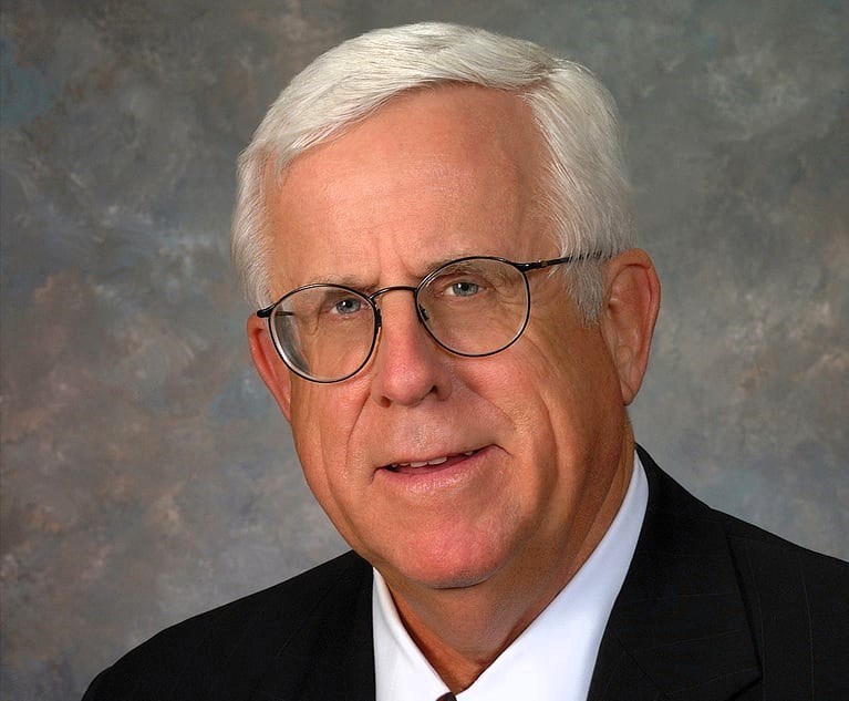 Portrait of Winstead co-founder Pete Winstead wearing a suit and glasses