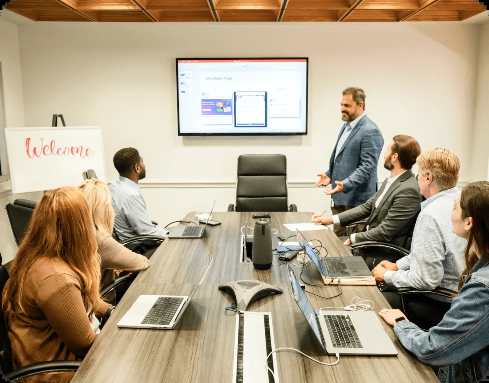 Wolfe colleagues discussing merchant workflows around a conference table