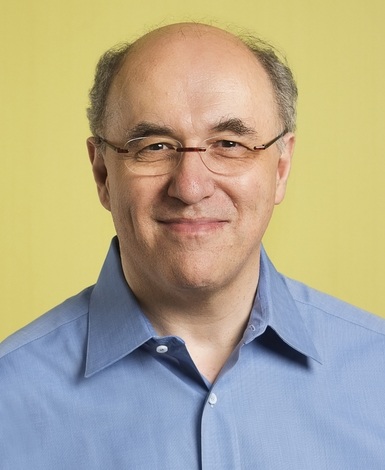 Stephen Wolfram wearing glasses and a blue shirt