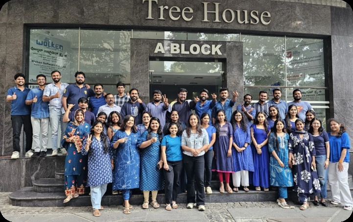 Wolken colleagues gathered for a group photograph outside a building