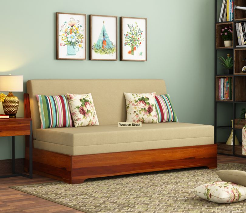 Della armless sofa bed in honey finish with cream upholstery and patterned cushions
