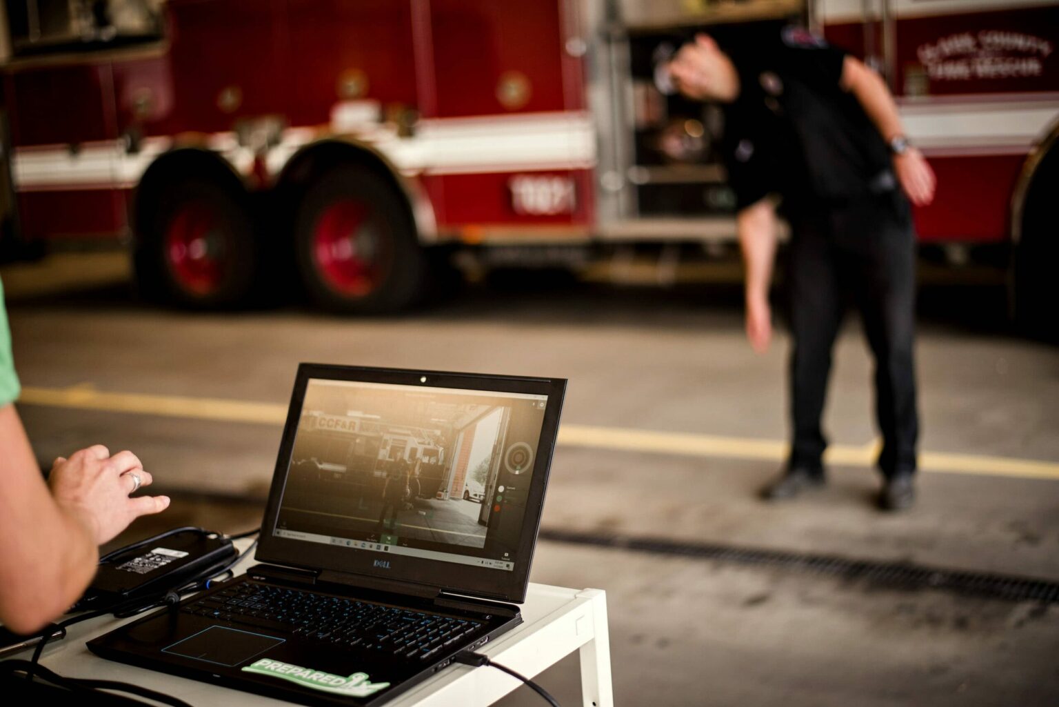A movement assessment displayed on a laptop while a worker moves in a fire station
