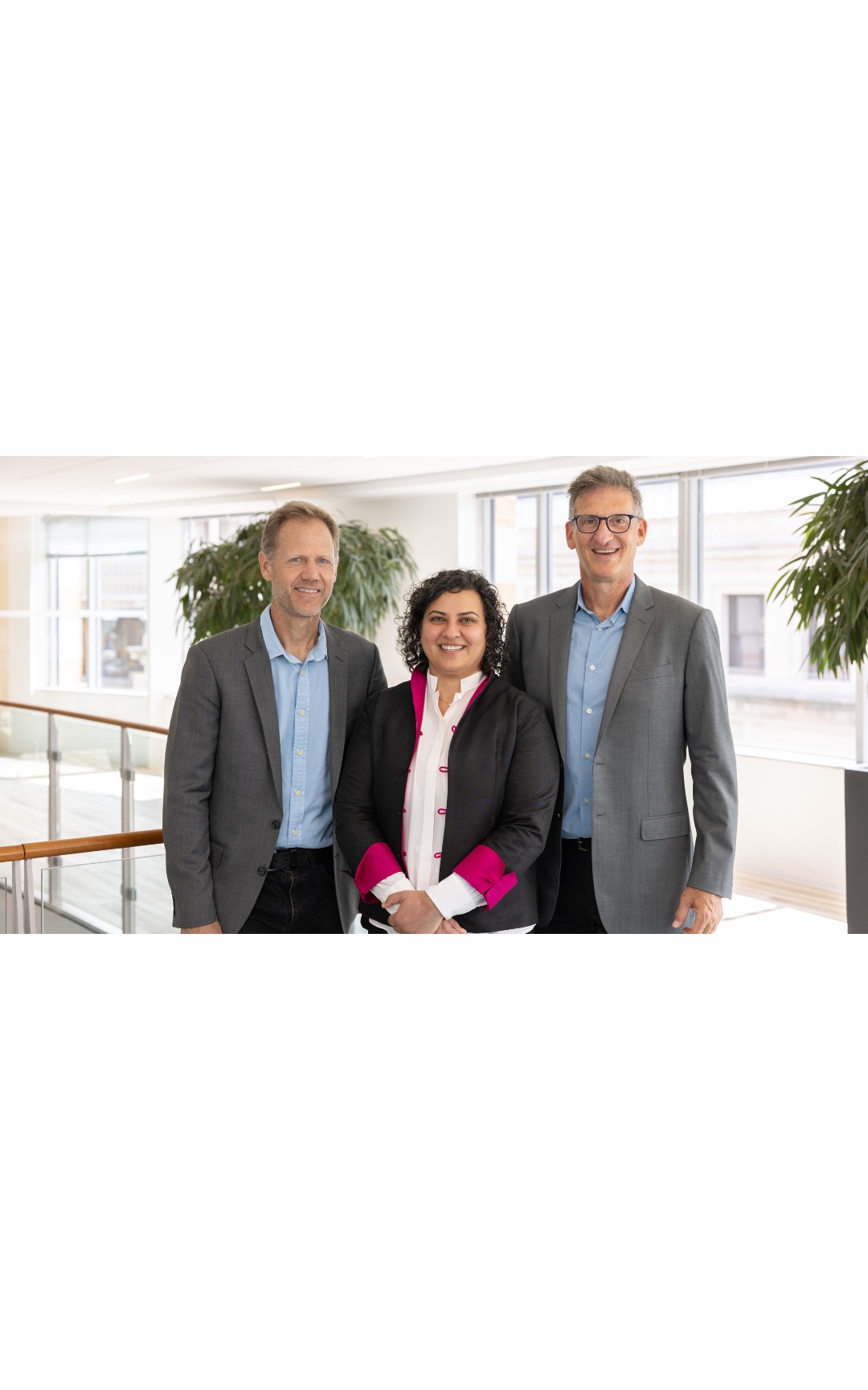 Three members of the Working Capital Fund team standing together in a bright office.