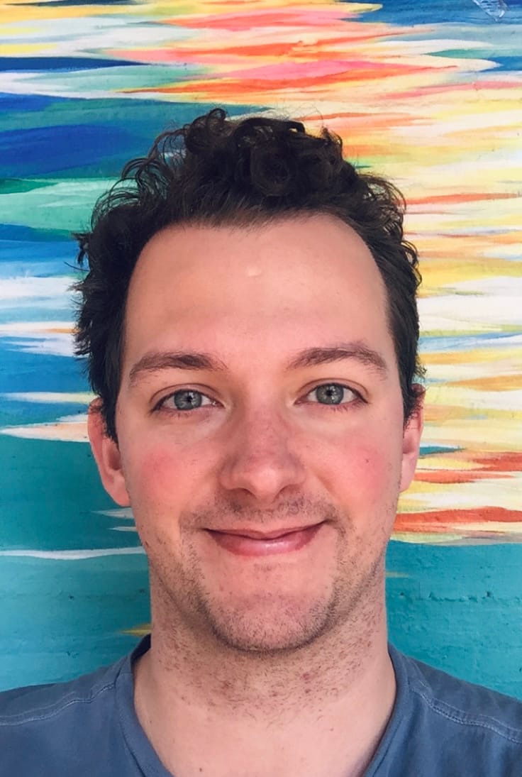 WorkOS founder Michael Grinich in front of a colorful painted wall