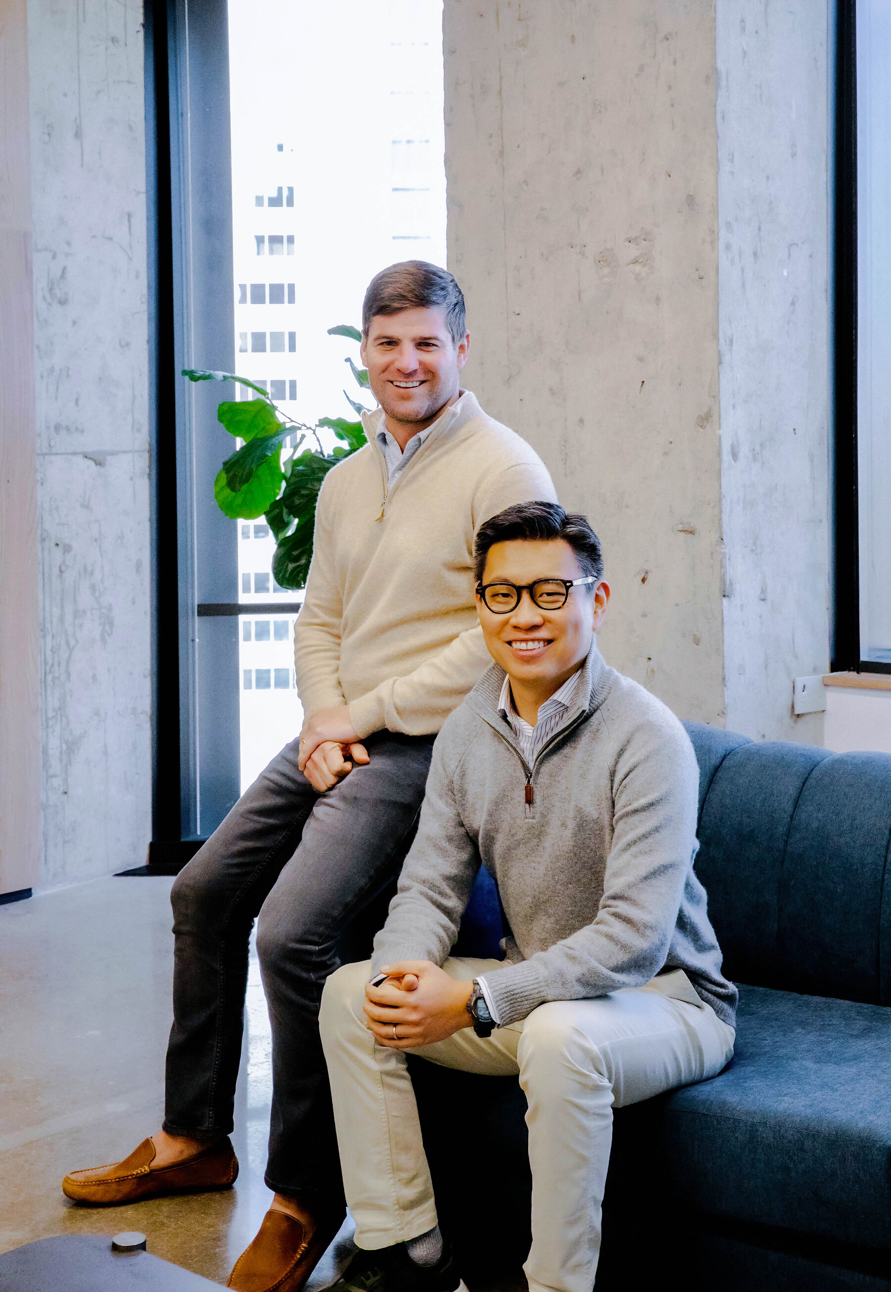 Co-founders Mike Witte standing beside Xuan Yong, seated, in a 2021 company portrait