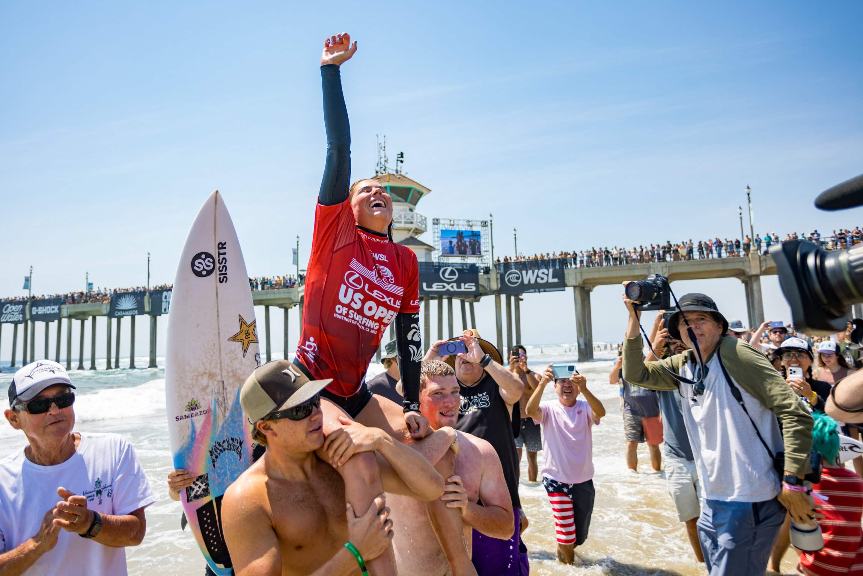Sawyer Lindblad is carried through a crowd beside Huntington Beach pier at the 2025 US Open of Surfing