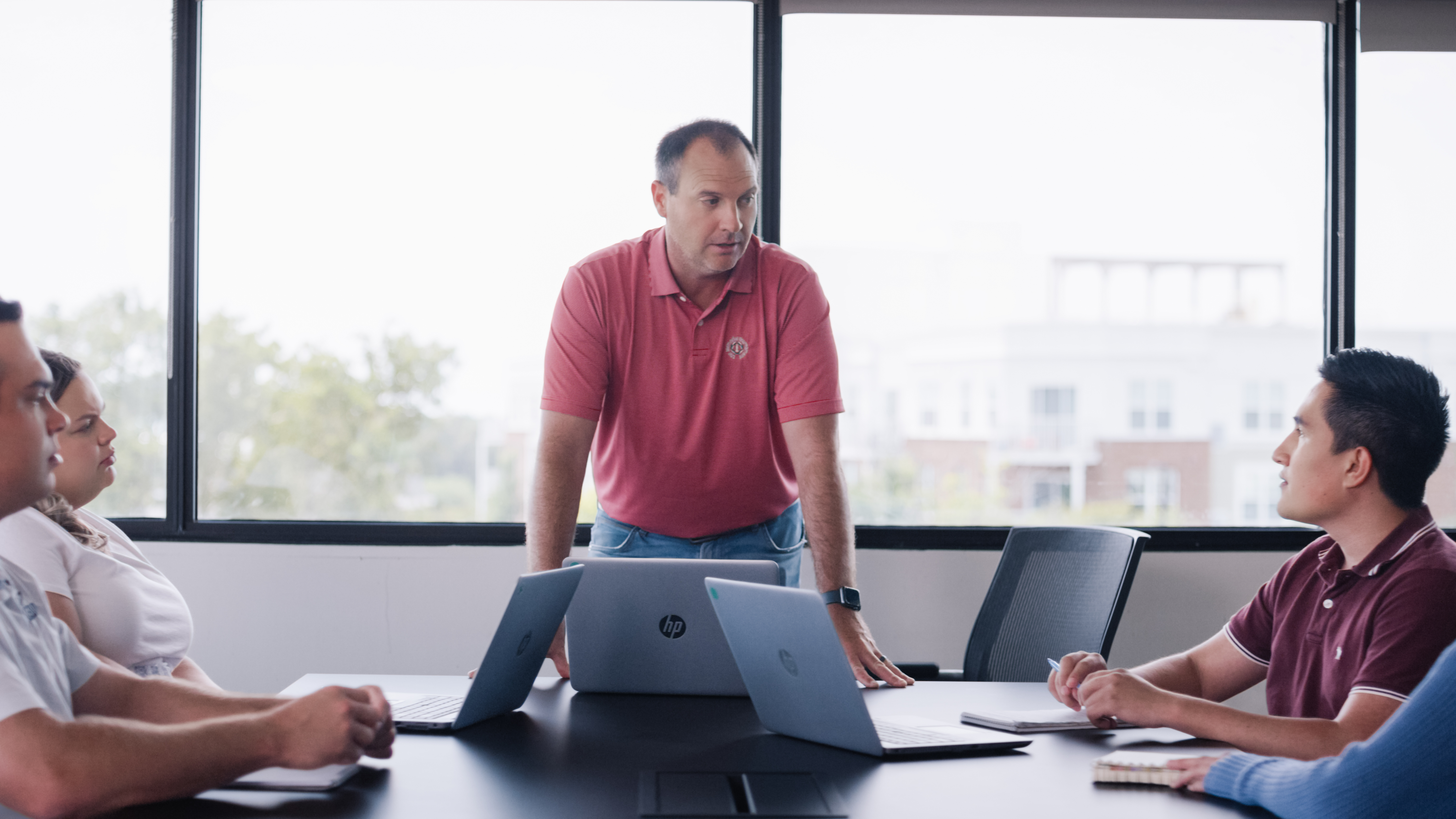 Worthington Steel employees discussing work around a meeting table