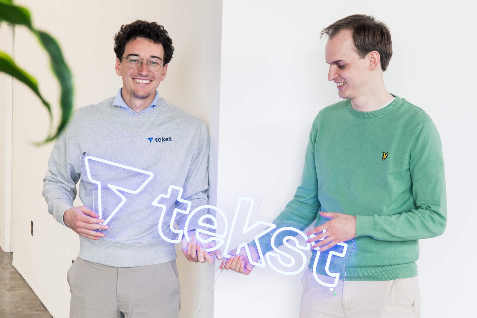 Wouter Janssen, left, and Tiebe Parmentier holding an illuminated Tekst sign
