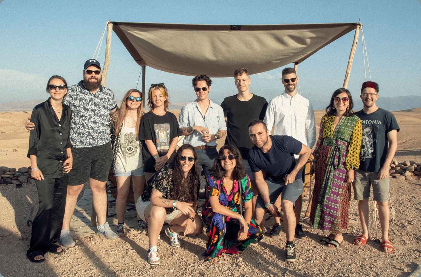 Wunderdogs team members gathered outdoors beneath a shade canopy