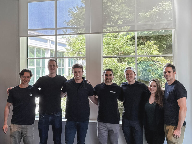Wyatt Ozmore, center, standing with six Owner.com colleagues after joining the company