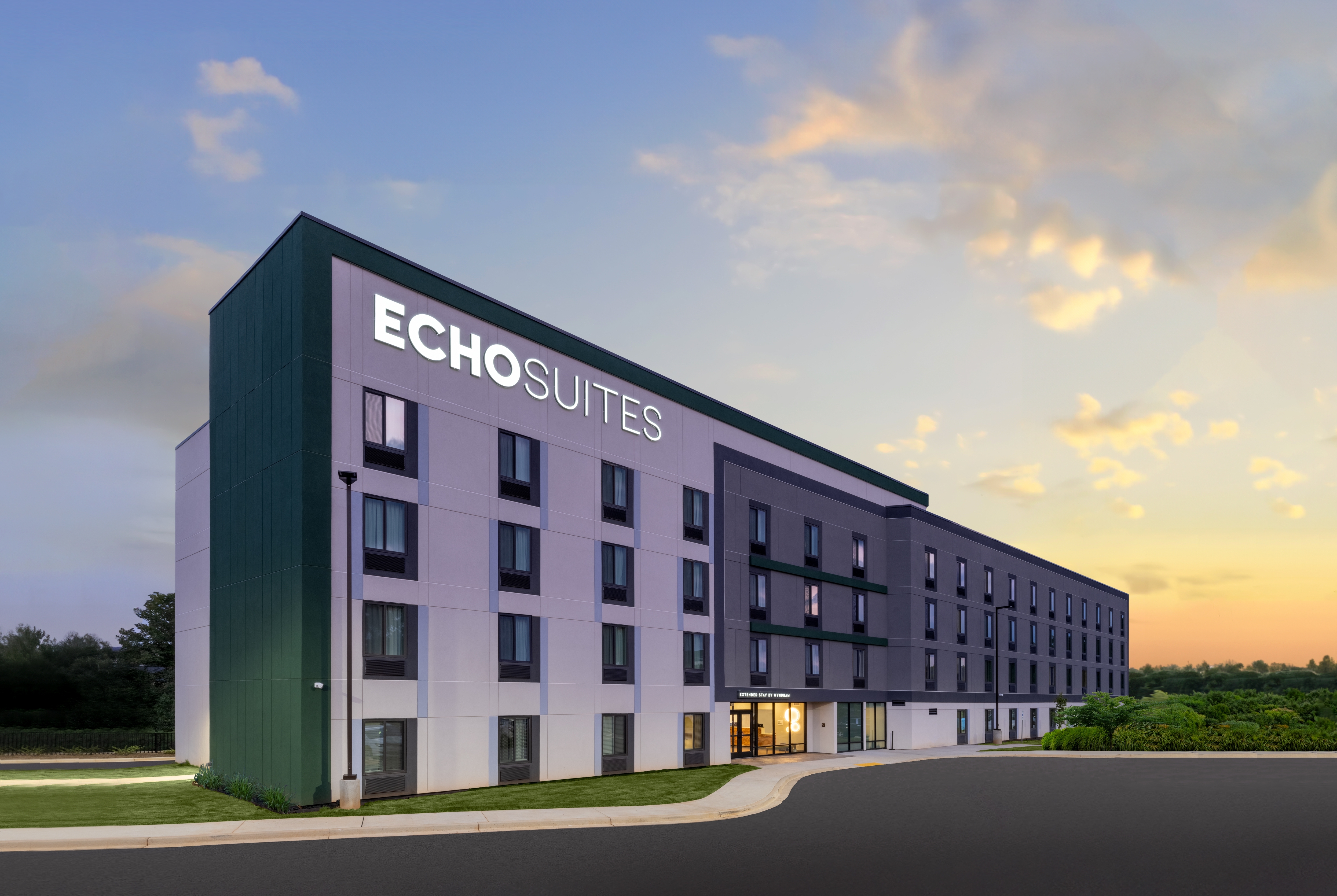 The green and gray exterior of ECHO Suites Extended Stay in Spartanburg, South Carolina