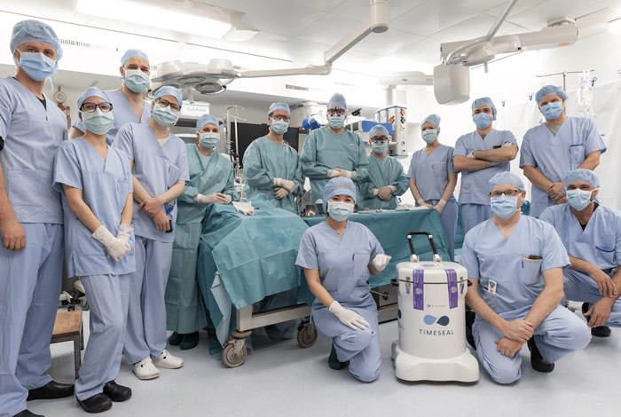 Surgical and research team gathered around the TimeSeal transporter