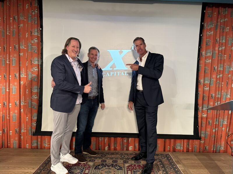 Three attendees posing at an X10 Capital investor meeting