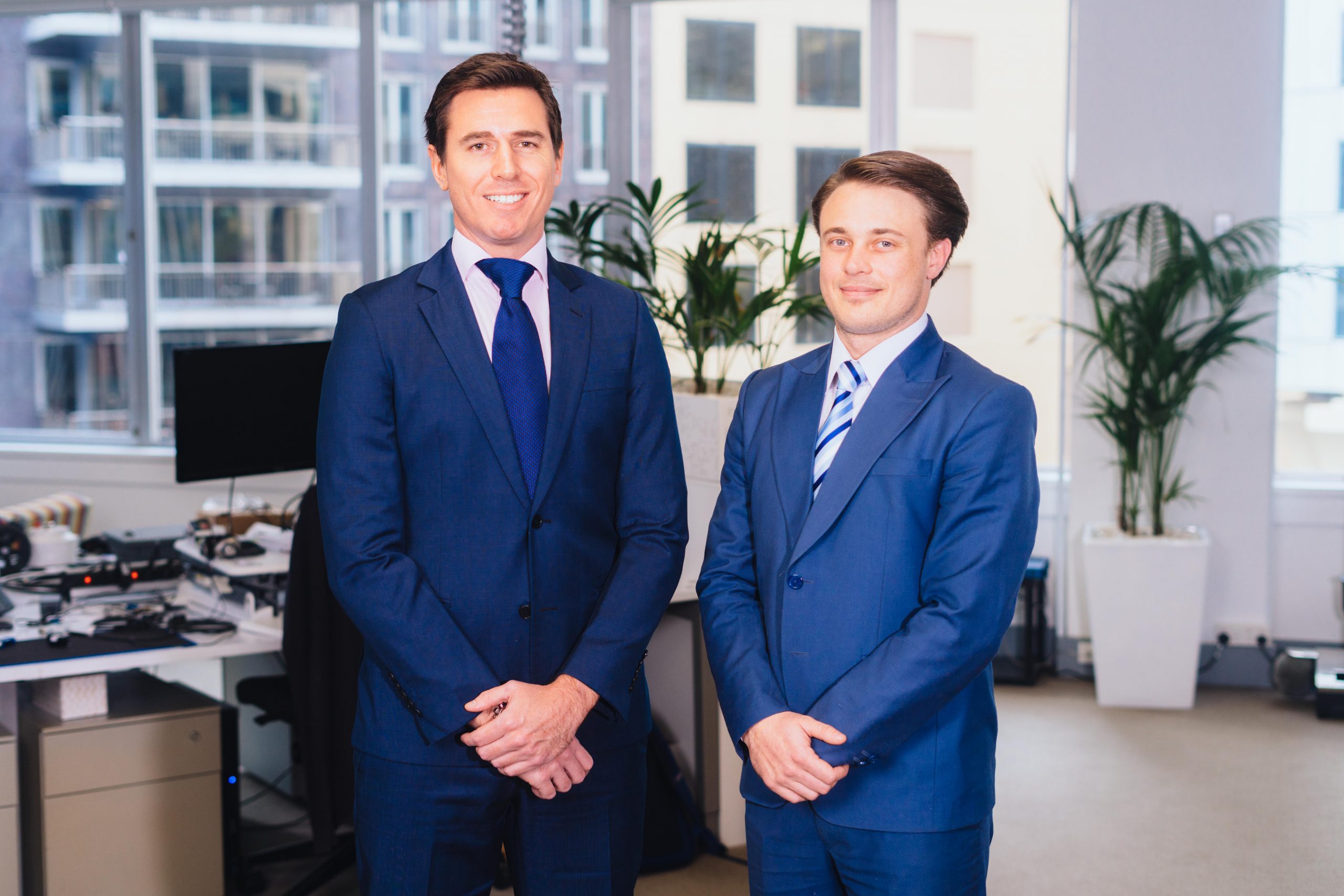 Chris Shaw, left, and Xavier Orr, right, standing together in an office