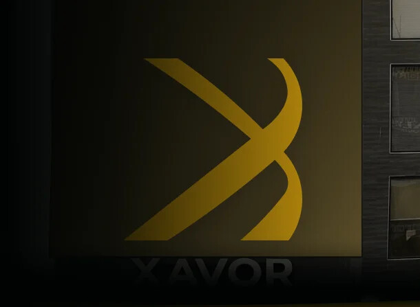 Xavor's illuminated mark inside a dark office setting