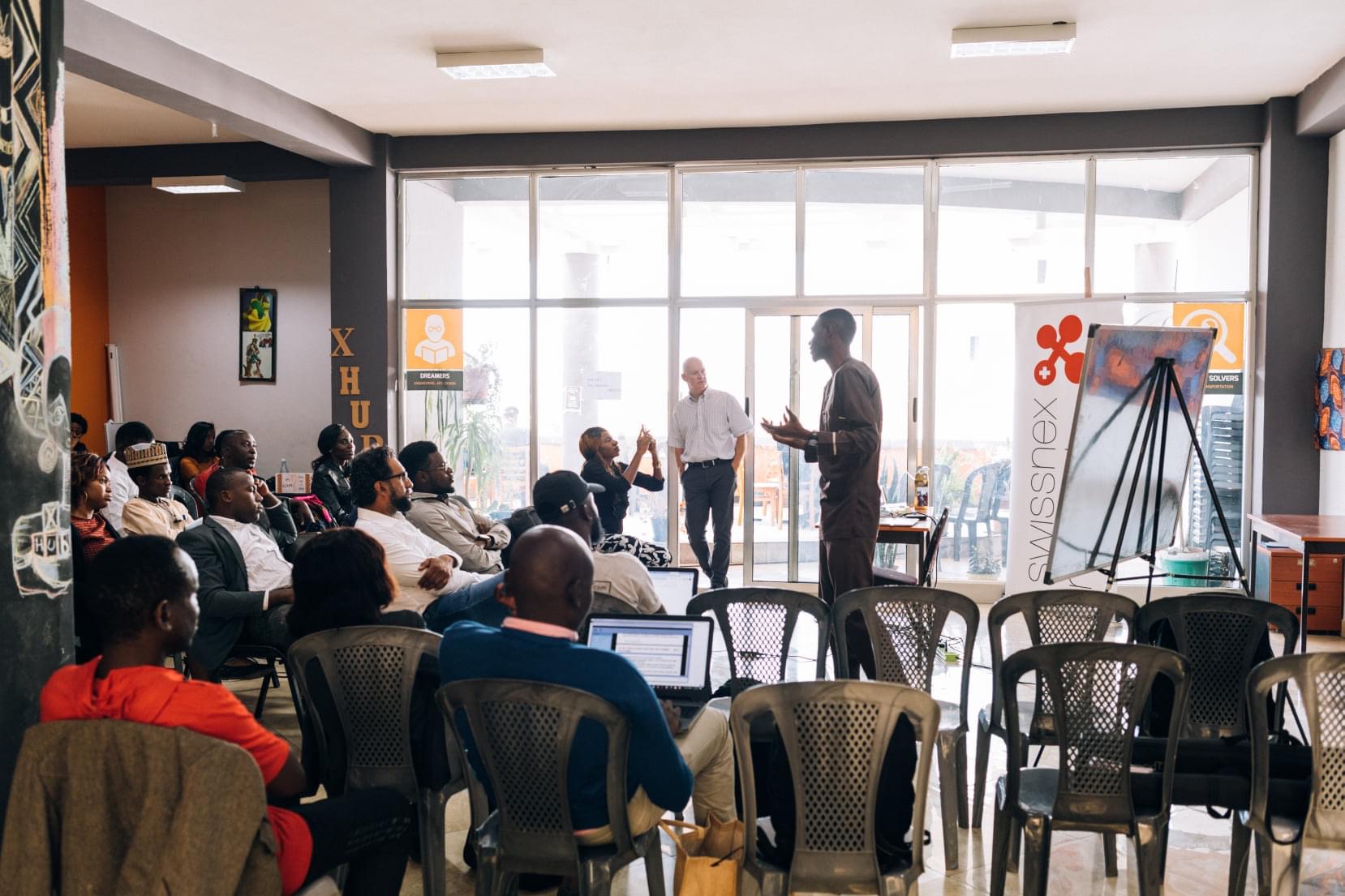 Participants listen to a speaker in xHub Addis’s light-filled community space