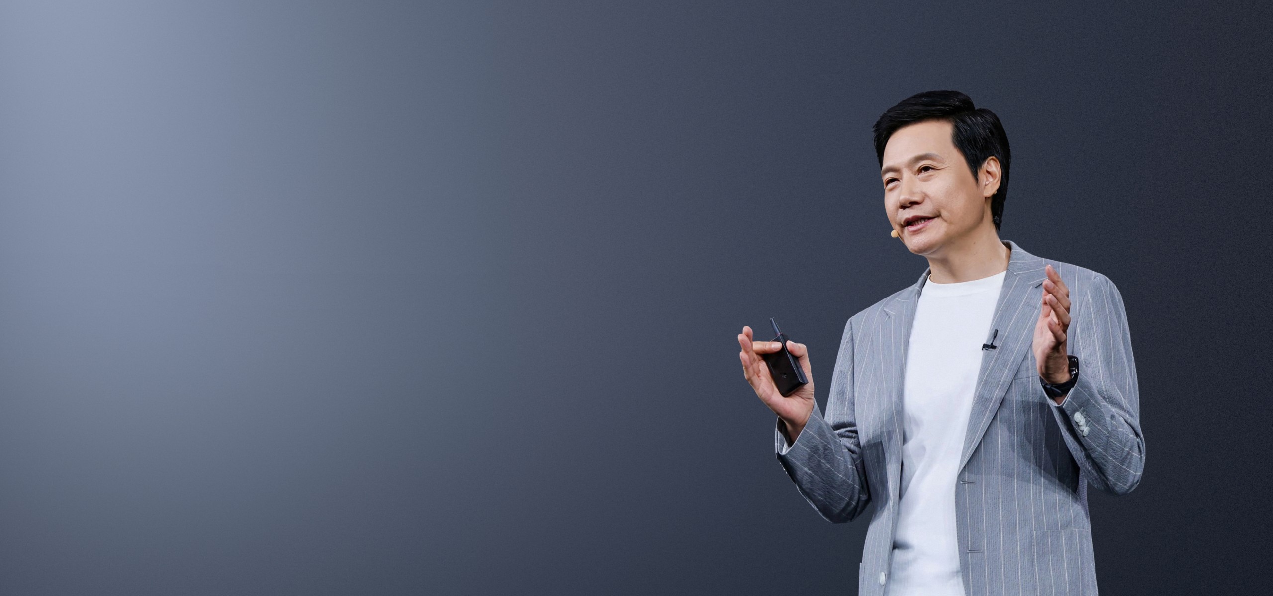 Xiaomi co-founder Lei Jun speaking with a presentation clicker in hand