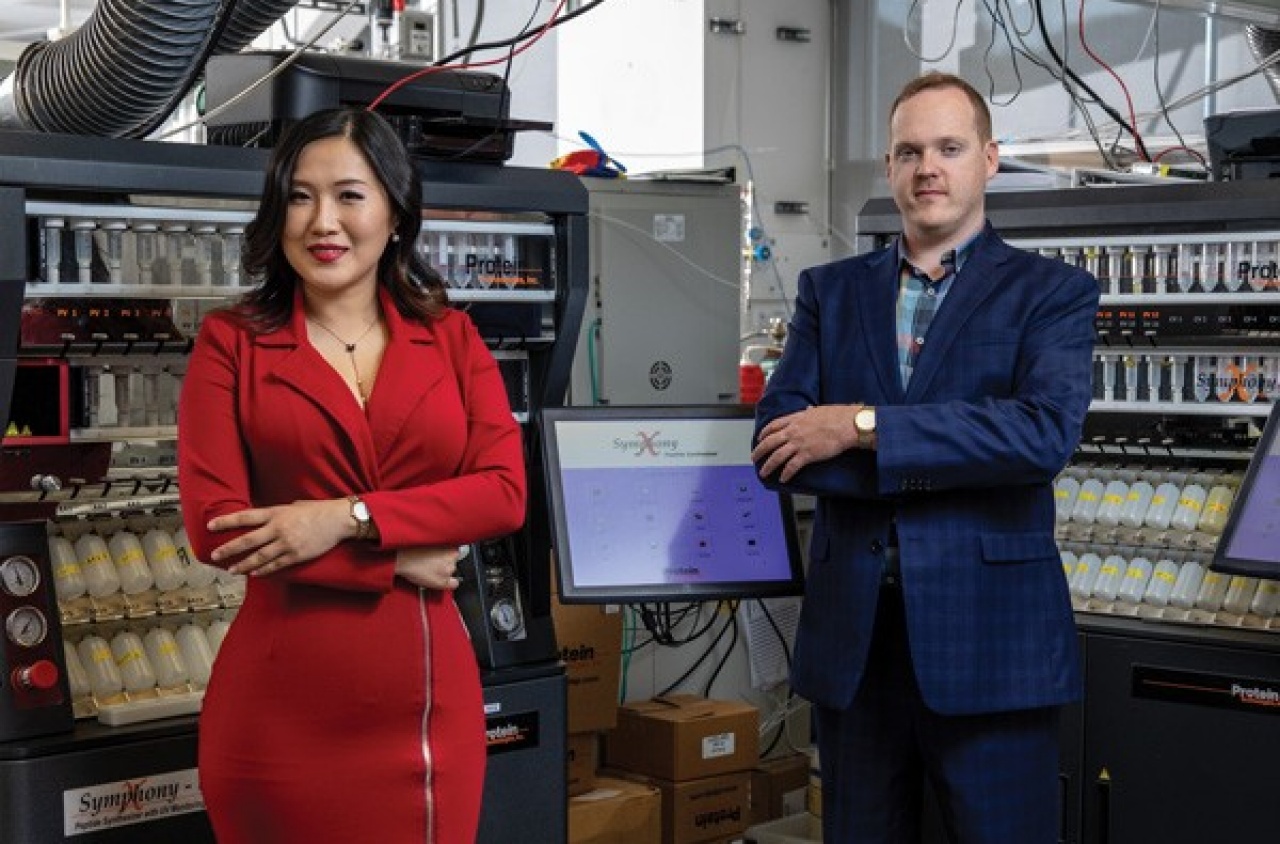Xiaoxi Wei in a red jacket and Mark Kline in a blue jacket, standing beside laboratory equipment at X-Therma