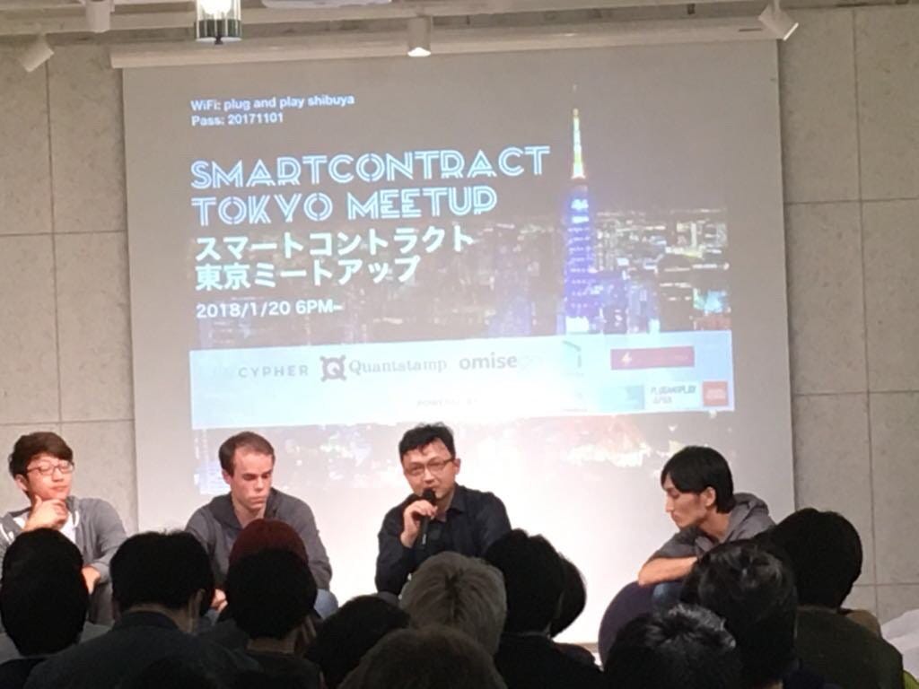 Xinshu Dong speaking into a microphone on a panel at the Smartcontract Tokyo Meetup
