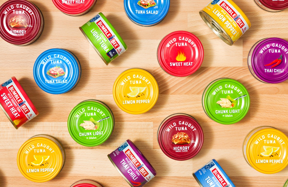 Colorful Bumble Bee tuna cans arranged on a wooden surface