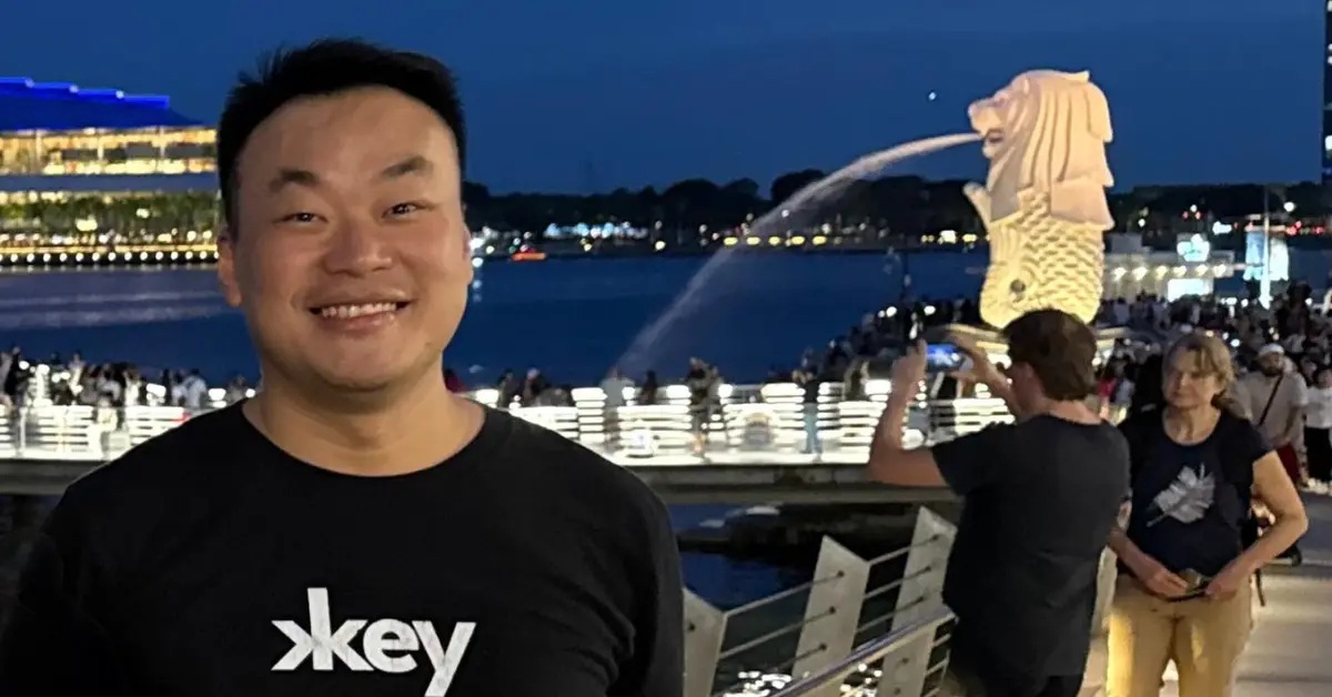 Christopher Fong beside Singapore’s waterfront and Merlion