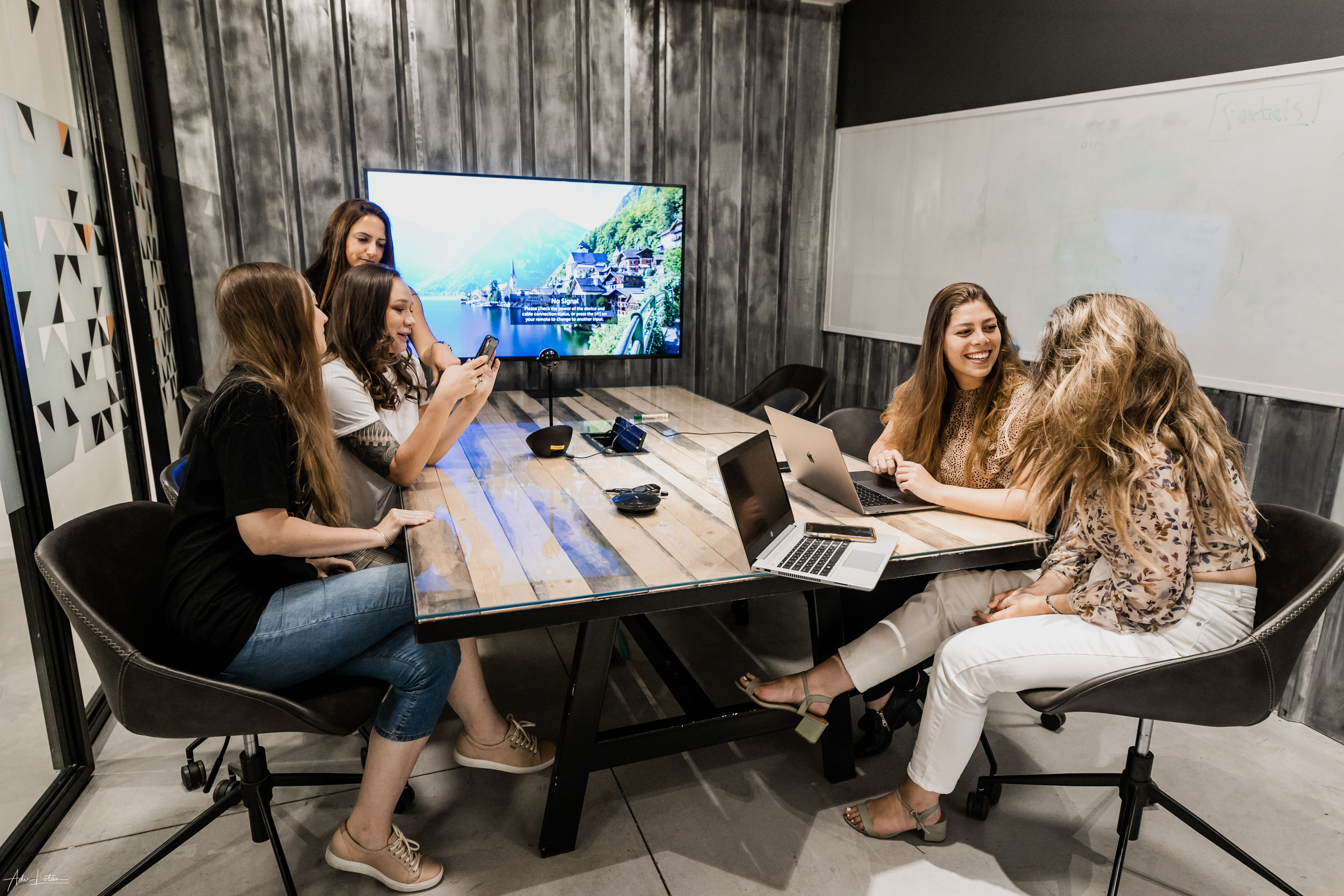 Yad2 colleagues gathered around a meeting room table