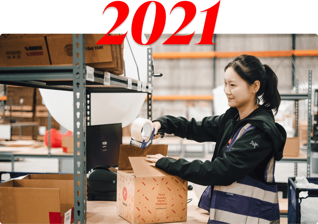 A Yami warehouse employee seals an order at a packing station