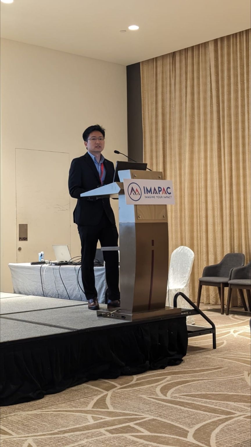 Yann Chong Tan speaking at a lectern during CGTWA2023