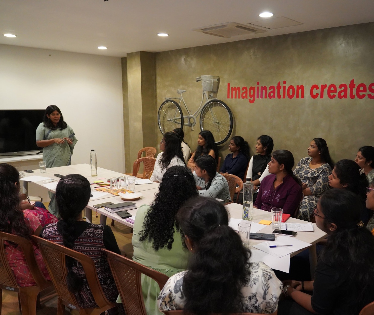 Women gathered around tables during a WEHub session