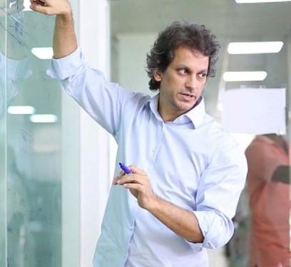 Yasser Bashir gesturing beside handwritten notes during a discussion
