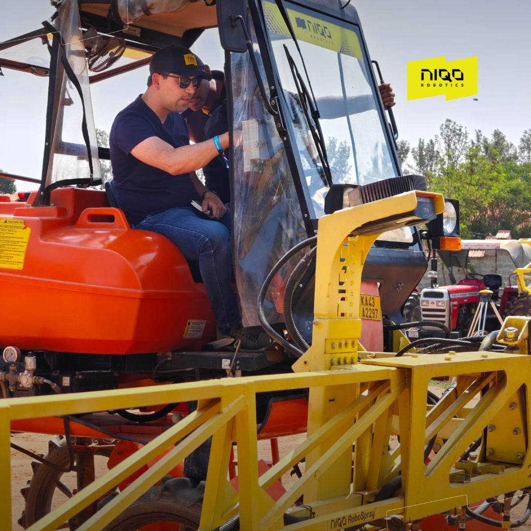 Yassine Cherkaoui seated in a tractor cab during Niqo Robotics’ May 2025 field demonstration