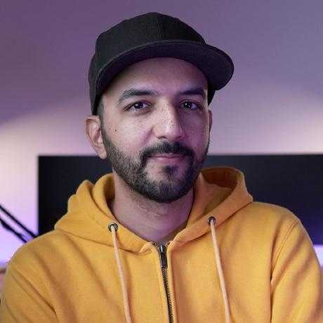 Yassir Ennazk wearing a baseball cap and a yellow hoodie, in the photograph on his GitHub profile