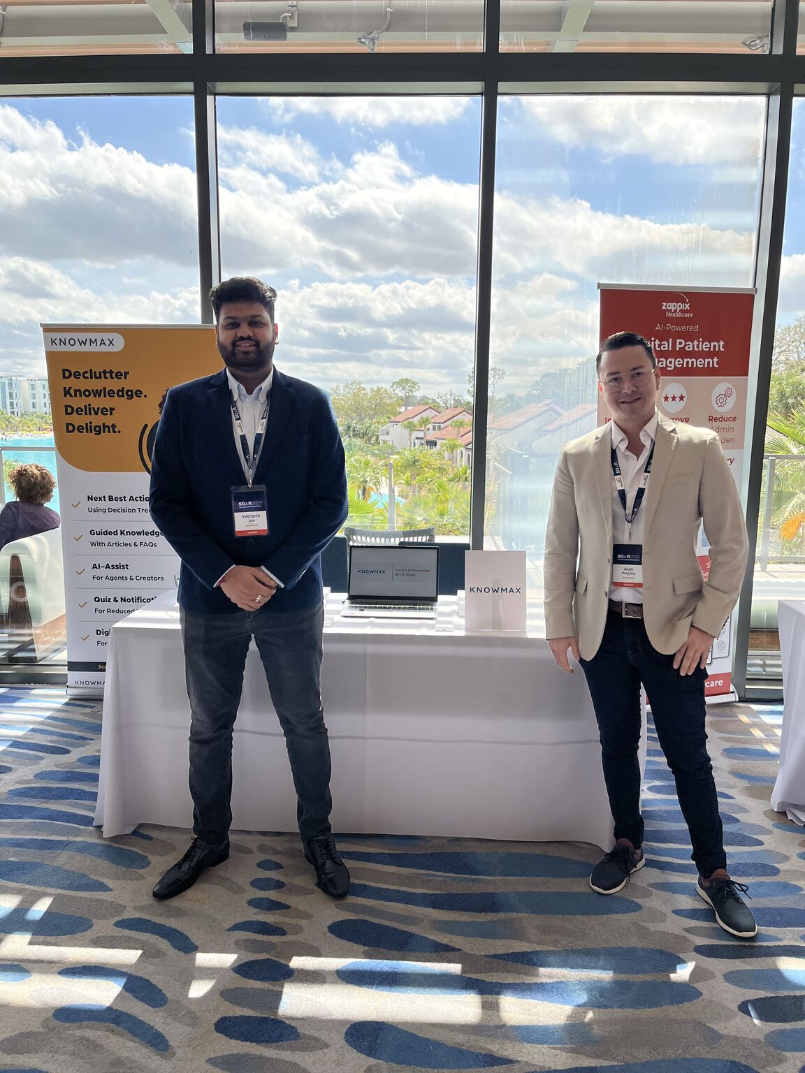 Yatharth Jain standing beside the Knowmax display at Firstsource's SOAR 2025 event in Orlando