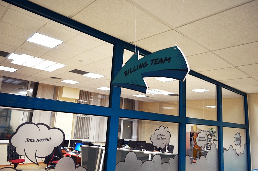 An arrow marked Billing Team above glass office partitions and computer desks